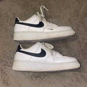 Black and white Nikes with gold